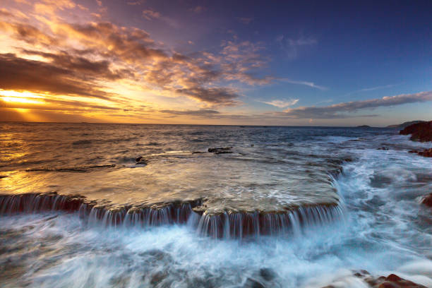 istock amazing landscape when the waves on a large rock and make an waterfall 650121798