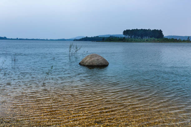 istock lake shore with pebbles and clear water 650125664