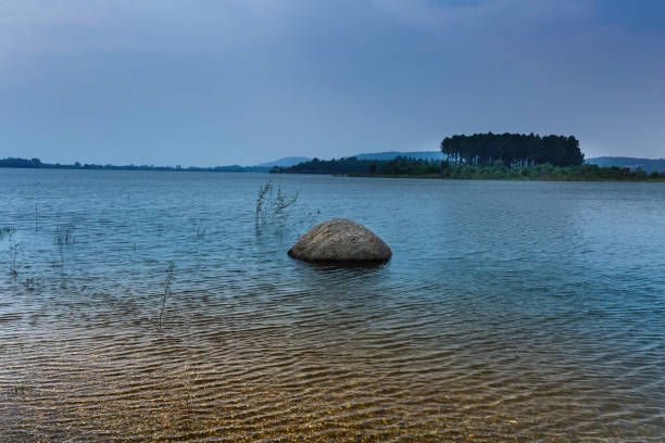 istock lake shore with pebbles and clear water 650125670