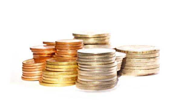 istock Many stacks of coins in various sizes and valued on white background 650129182
