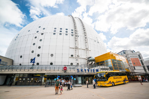 Stockholm, Sweden - August 5, 2016: Ericsson Globe, also known as Stockholm Globe Arena, famous largest hemispherical building in the world, used for sports and entertainment events. People sightseeing around.