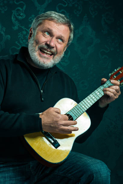 istock Studio portrait of senior man with guitar 650136900