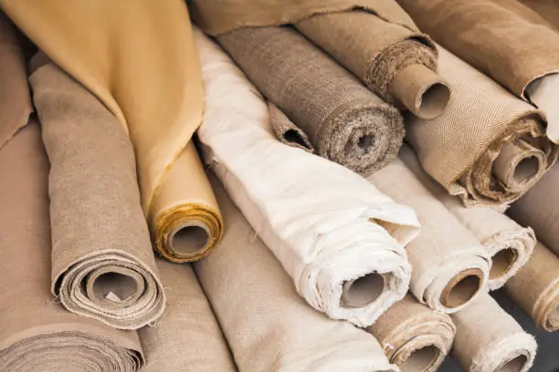 Photo of Rolls of  linen cloth lie on counter