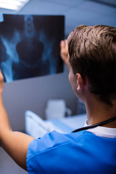 istock Male doctor examining x-ray report 650144834