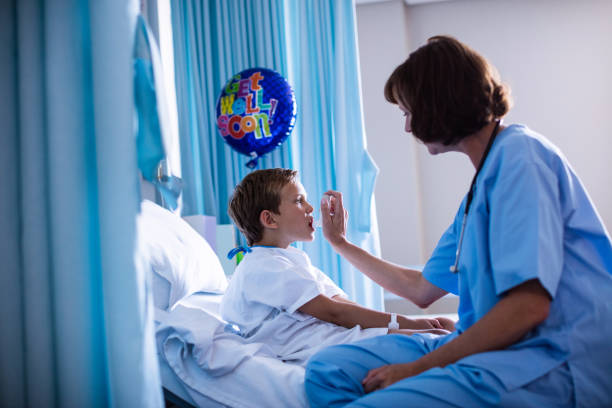 istock Female doctor using inhaler on patient 650146104