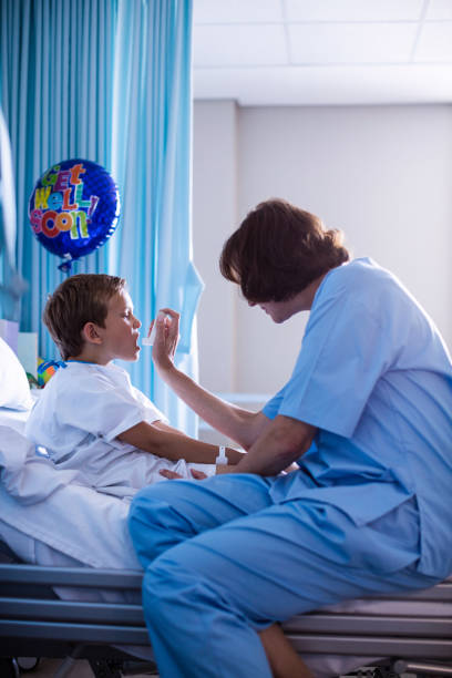 istock Female doctor using inhaler on patient 650146156