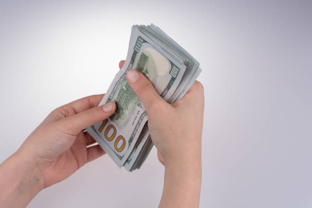 istock Human hand holding American dollar banknotes on white background 650168914