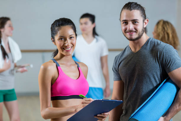 istock Female trainer helping man on her work out routines 650170058