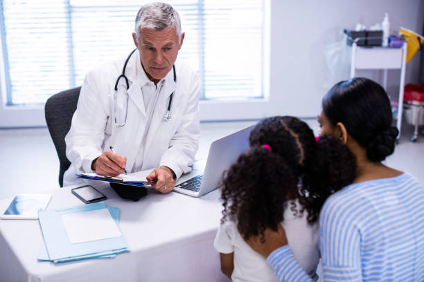 istock Doctor writing on clipboard while consulting patient 650170268