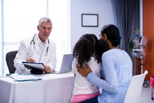 istock Doctor writing on clipboard while consulting patient 650170332