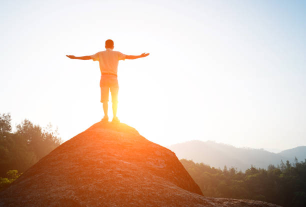 istock Man success standing at mountain peak 650171116