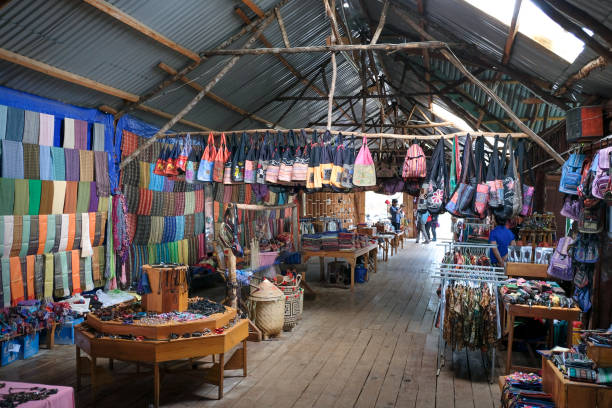 shop selling brocade, clothes, and hand-woven headwear of ethnic minority Da Lat town, Vietnam - February 19, 2017: inside a shop, where specially in selling brocade, clothes, and hand-woven headwear of ethnic minority people in the village, near Dalat town, Vietnam vietnamese girls for sale stock pictures, royalty-free photos & images