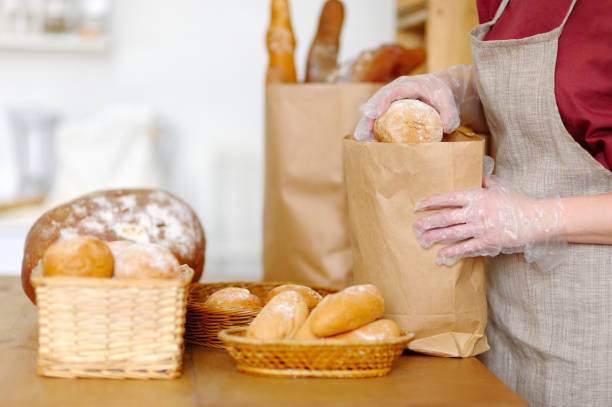 istock Bread seller holding a package of food. 650174792