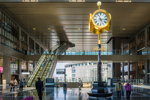 The iconic gold clock in the grand concourse of Osaka Station overlooking commuters, shoppers and travellers in Japan's second city.