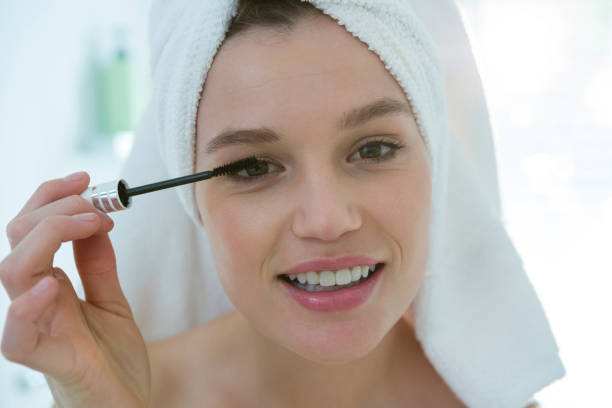 istock Woman applying mascara on eyelashes in bathroom 650175182
