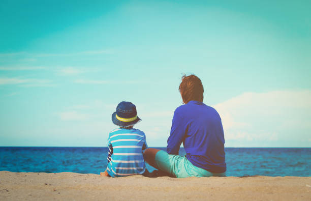 istock father and little son talking on beach 650176994