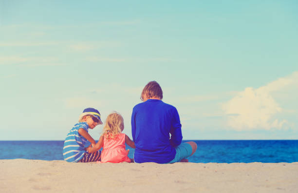 istock father with little son and daughter on beach 650177090