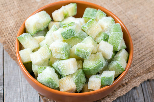 istock Frozen zucchini in a bowl on a wooden background 650182636