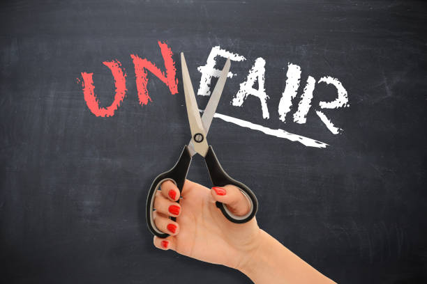 istock Woman doing justice to herself by cutting the word “unfair” , changing into fair 650182996