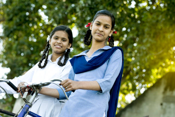 istock Schoolgirls with bicycle 650183174