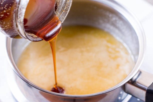 istock Pouring liquid honey in a bowl 650183784