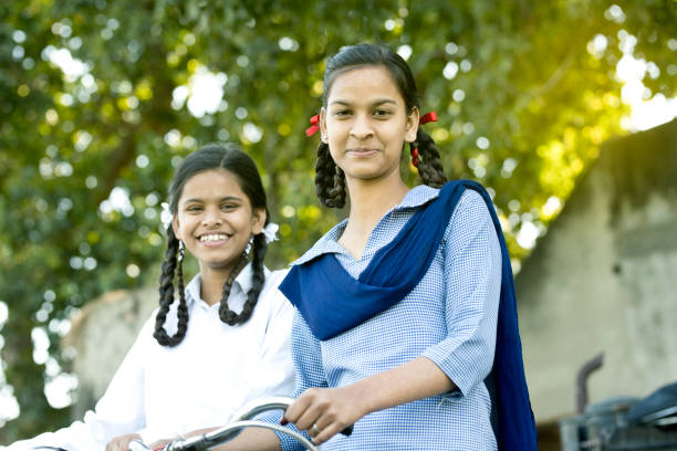 istock Schoolgirls with bicycle 650184412