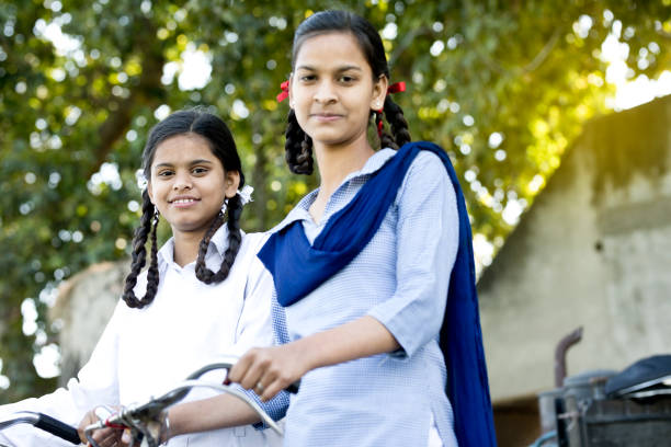 istock Schoolgirls with bicycle 650190310