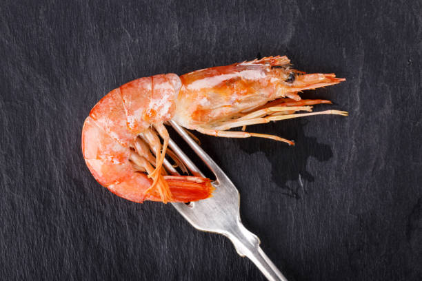 istock Red argentine shrimps (head on) on black 650190520