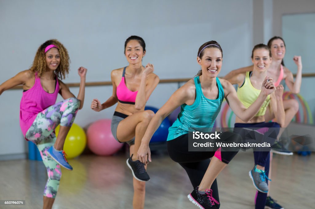 Group of women performing aerobics Group of women performing aerobics in fitness studio Aerobics Stock Photo