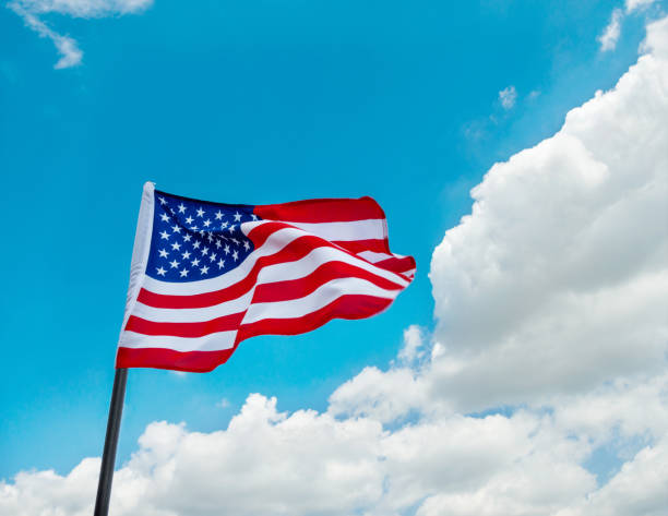 istock American flag waving against blue sky 650196668