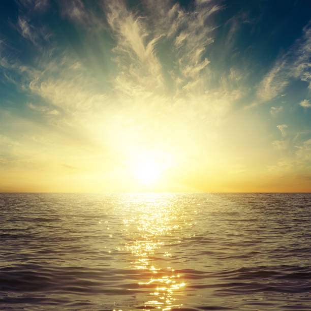 istock bright sunset in clouds over dark sea 650209738