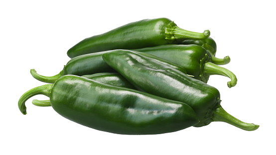 Pile of green Anaheim chile peppers (Capsicum annuum), the mild variety of New Mexico (Numex) chile No. 9. Clipping paths, shadowless