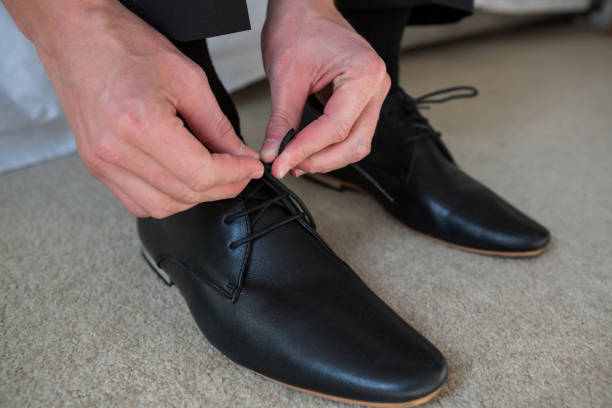 istock Man tying a shoelaces in bedroom 650223652