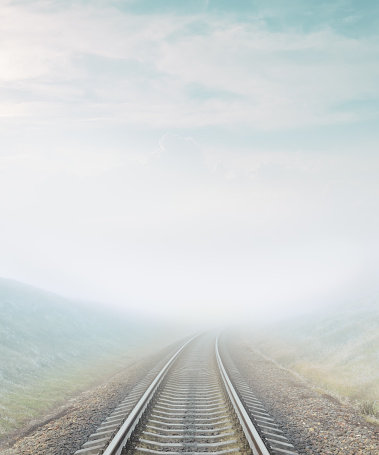 railroad goes to horizon in fog