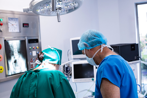 Male and female surgeon working in operation theater of hospital