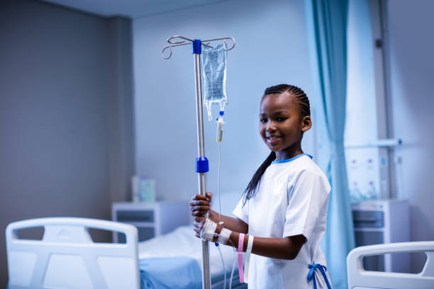 istock Patient holding IV stand at hospital 650233002