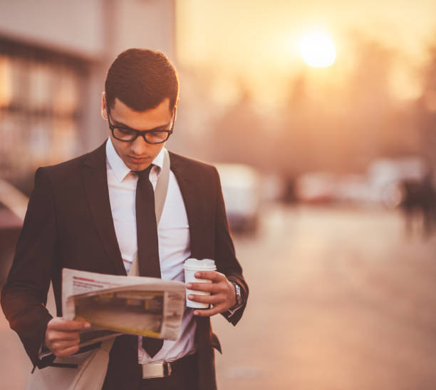 istock Businessman reading newspaper 650238136
