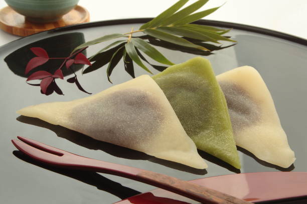 Bean Paste Wrapped in Cinnamon-flavored Dough Yatsuhashi, Japanese Kyoto sweets Type of sweet made with red bean paste (local delicacy in Kyoto, Japan); cinnamon-seasoned steamed dough made from ground rice adzuki bean photos stock pictures, royalty-free photos & images