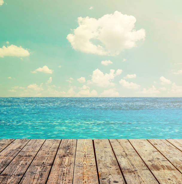 istock Blue ocean and sky above wooden floor 650246532