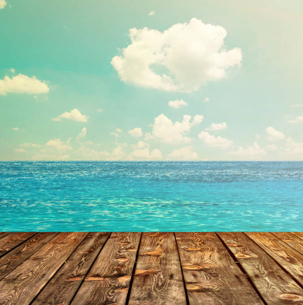 istock Blue ocean and sky above wooden floor 650246538