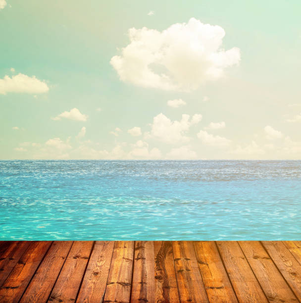 istock Blue ocean and sky above wooden floor 650246546