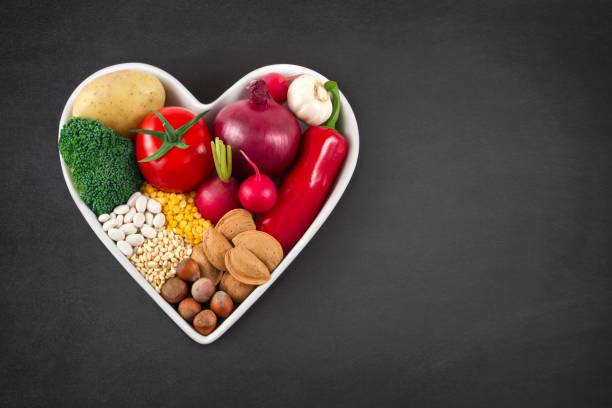 istock Vegetables in Heart Shaped Bowl on Blackboard 650247314