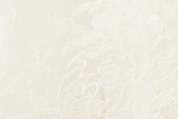 Closeup of white wedding lace with floral pattern