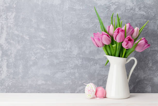 istock Easter eggs and pink tulips bouquet 650247942