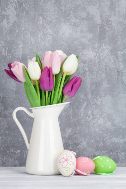 istock Easter eggs and colorful tulips 650248058