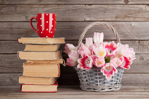 istock Pink tulips bouquet, books and coffee cup 650250588