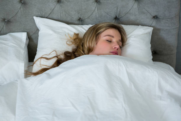 istock Young woman sleeping on her bed 650250966