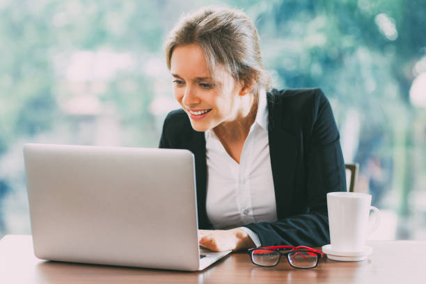 istock Young Smiling Businesswoman Working on Laptop 650257584