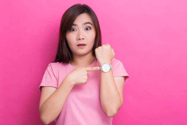 istock Shy woman check her watch she is late 650257802