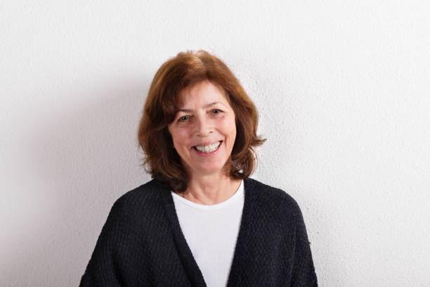 istock Senior woman in black woolen sweater, studio shot. 650258278